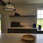 Kitchen remodel with open floating shelves and white marble countertops.